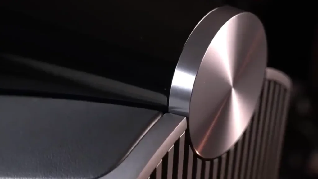 Rear aluminum top plate detail of the Bowers & Wilkins 801 D4 showing precision-machined circular metal reinforcement and cabinet junction.