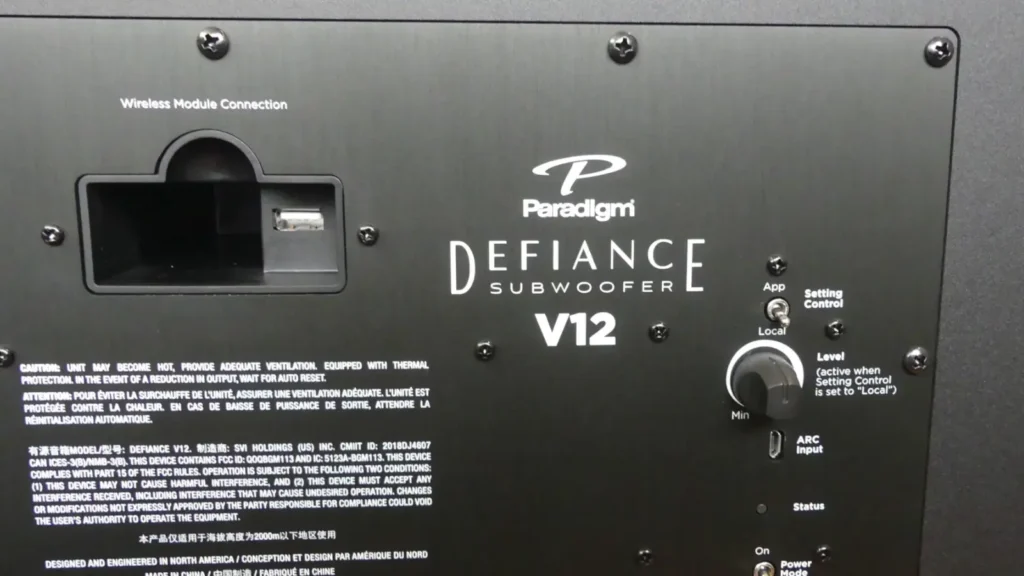 The back panel of the Paradigm Defiance V12 showing the volume level knob, AppLocal toggle switch, and the ARC (Anthem Room Correction) input port.