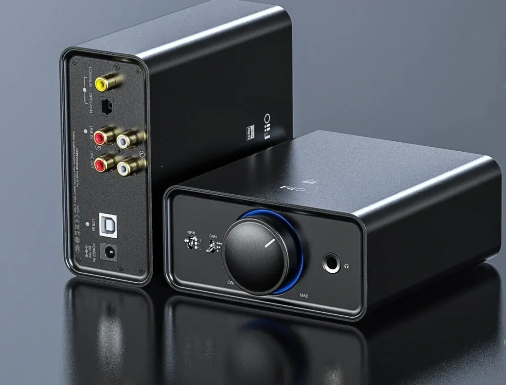 FiiO K5 Pro DAC and amplifier, black aluminum casing with volume knob, headphone jack, and various input/output ports.