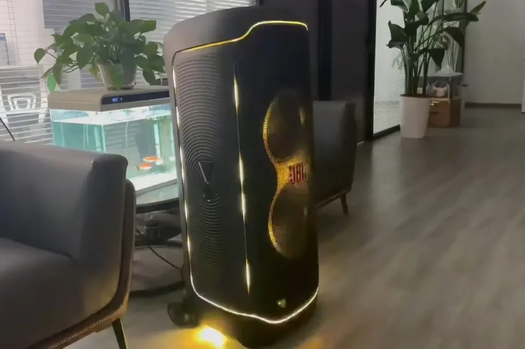 Aa closer look of JBL PartyBox ultimate in yellow color lights on while playing