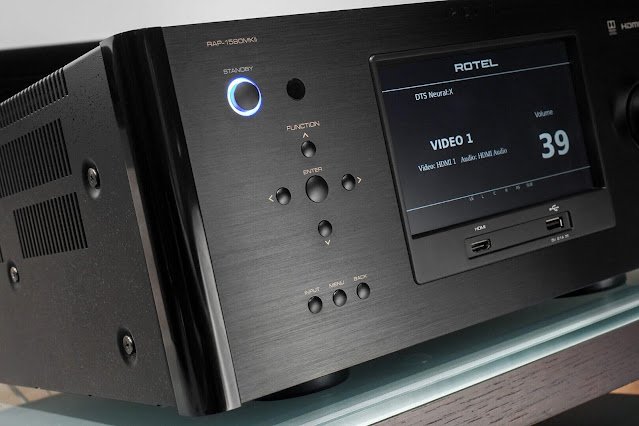 Close-up view of the Rotel RAP-1580MKII, showcasing its sleek black design, illuminated standby button, central control knobs, and a detailed display screen with HDMI and audio settings