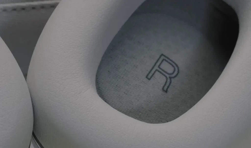 A Closer Look of the 'R' indicator inside the light grey earcup of the Bowers & Wilkins Px7 S2 wireless headphones.