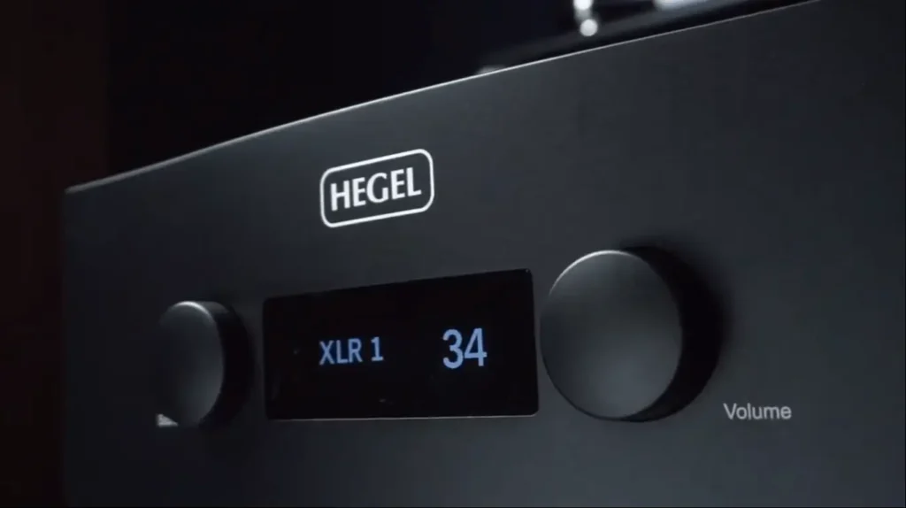 A close-up, look of the Hegel H590 amplifier's front panel, with its display lit up during a review of the Klipsch RF-7 III speakers.