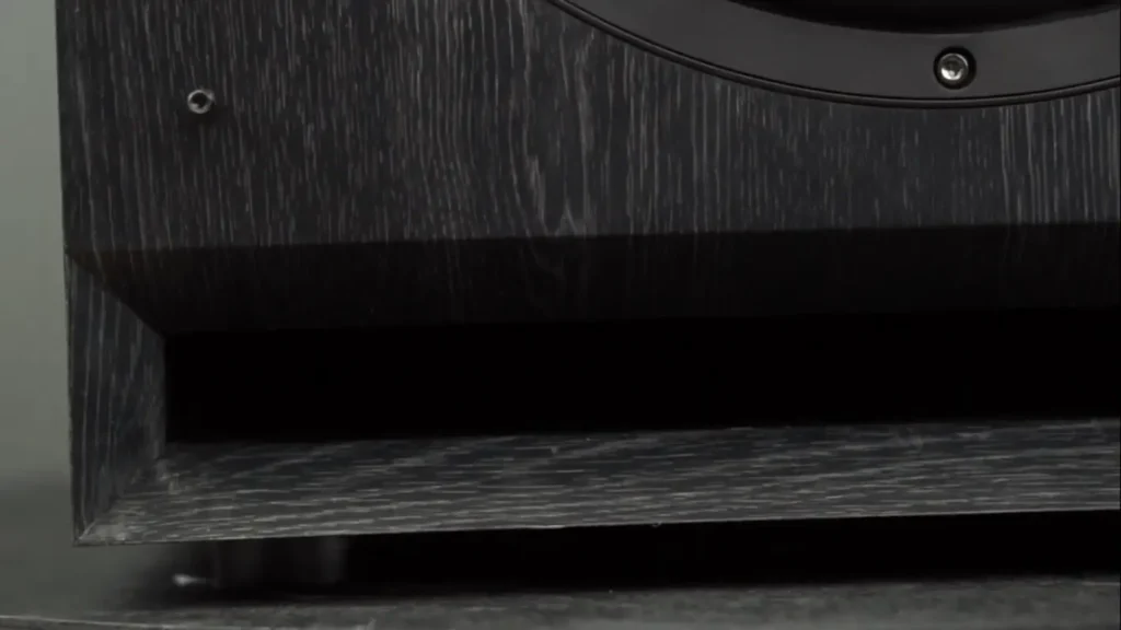 A close-up, low-angle shot of the bottom front of my Klipsch SPL 120 subwoofer, showing the slotted bass reflex port