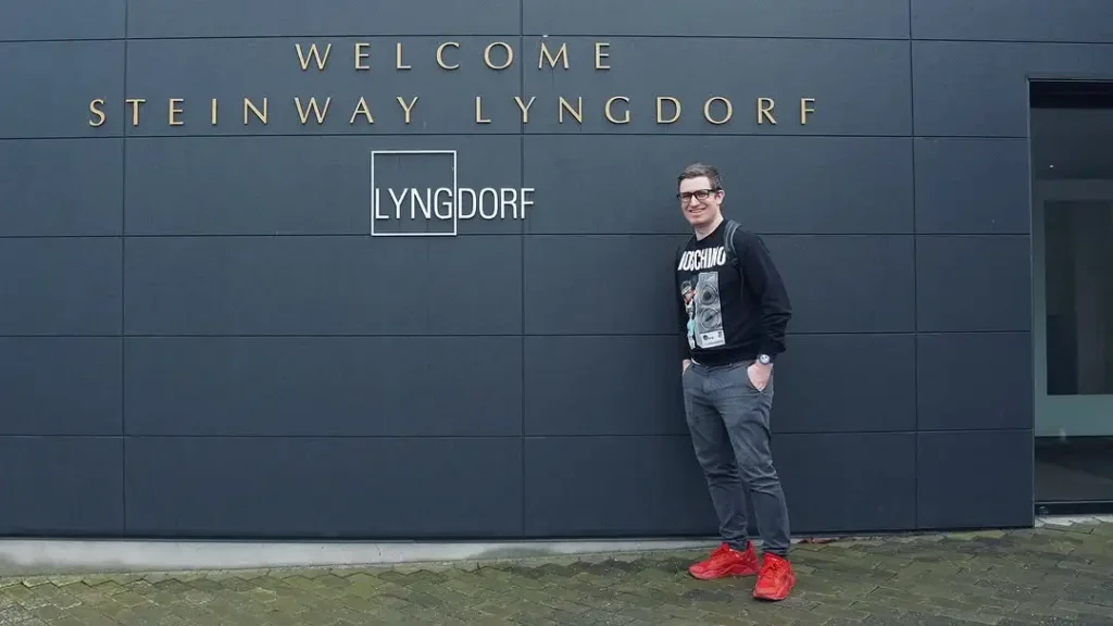Alex the author, smiling while standing outside the Steinway Lyngdorf headquarters, the company that makes my audio processor.