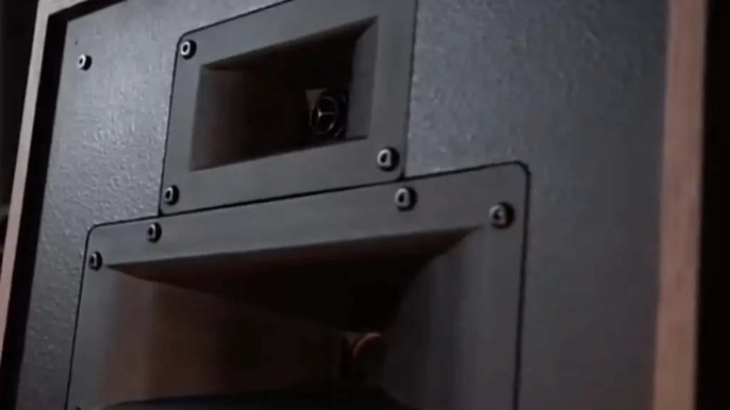 A close-up of the Klipsch Heresy IV showing the horn-loaded tweeter and midrange compression drivers on the black speaker baffle