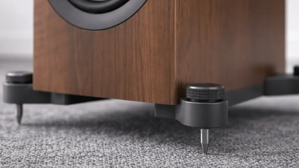 Close-up of KEF Q750 floorstanding speaker feet with adjustable metal spikes 