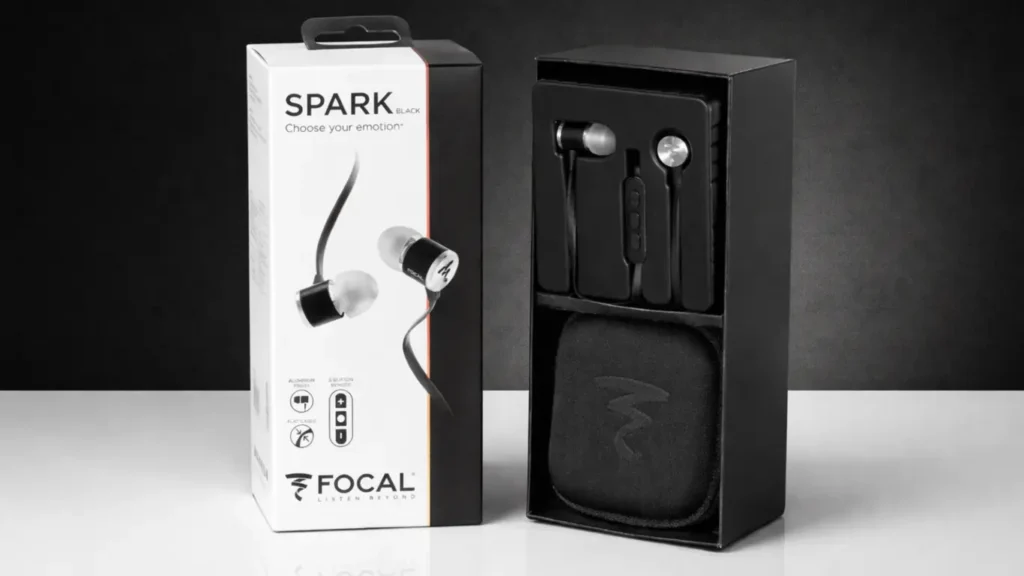 Focal Spark Black in-ear headphones displayed with retail box, open packaging, earbuds, and carrying case