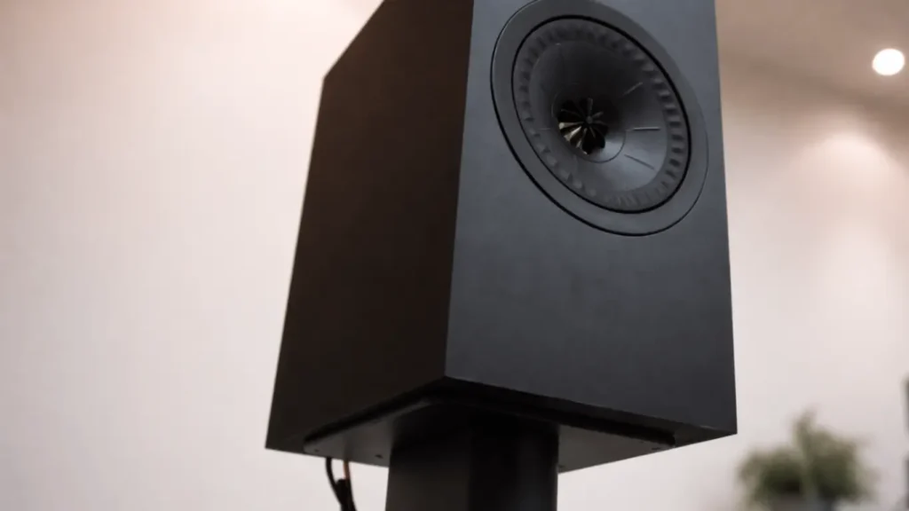 KEF Q150 black bookshelf speaker mounted on a professional speaker stand.