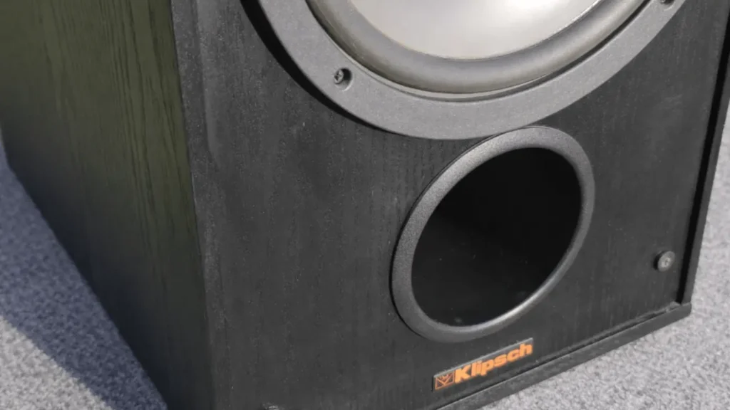 Klipsch KG 5.5 speaker front bass reflex port with black wood cabinet finish and Klipsch logo