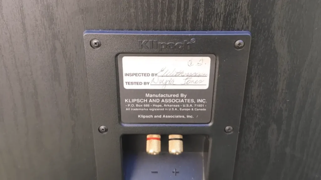 Rear panel of Klipsch KG 5.5 speaker showing manufacturer label, serial inspection tag, and binding posts