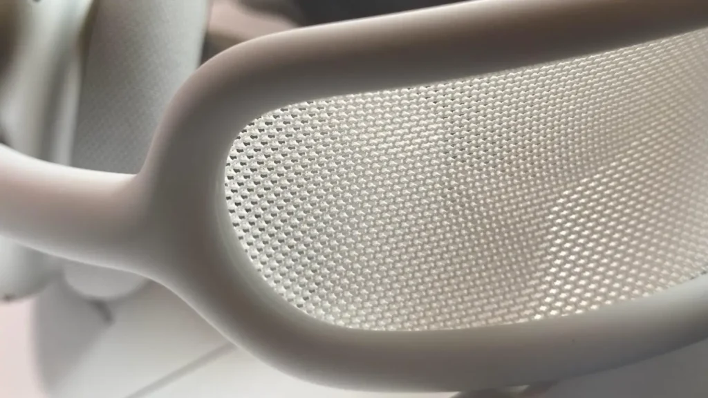 Close-up macro shot of the AirPods Max 2 woven mesh headband showing the fine textile weave and aluminum frame detail